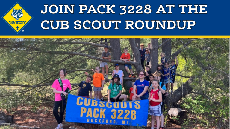 An image of scouts on a hike holding a banner that says "Cub Scout Pack 3228 - Rockford, MI". The Cub Scout Logo and the Text "Join Pack 3228 at the Cub Scout Roundup" is displayed on a blue banner at the top of the image.